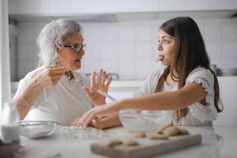 A grandmother is shocked by her granddaughter eating more than her fair share of the cookies